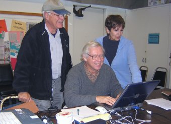 Photograph of 3 Omnilore Members at a computer